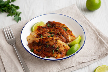 Homemade Pan Seared Tilapia on a Plate, side view.