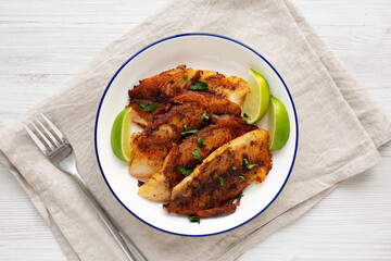 Homemade Pan Seared Tilapia on a Plate, top view. Flat lay, overhead, from above.