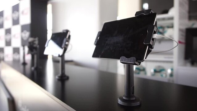 Slow rotating bokeh shot of tablets at reception to sign in to