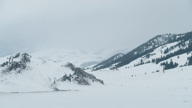 Wide shot of low hills and mountains in western Wyoming.  Shot in 4K
