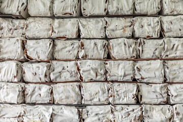 The natural Thai standard rubber bales sheet products staked and stored in the factory’s...