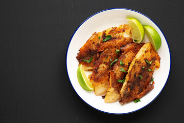 Homemade Pan Seared Tilapia on a Plate, top view. Flat lay, overhead, from above. Space for text.