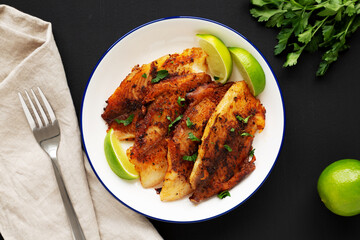 Homemade Pan Seared Tilapia on a Plate, top view. Flat lay, overhead, from above.