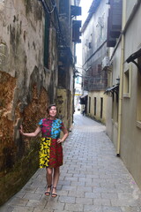 Obraz na płótnie Canvas Girl poses in ancient Stone Town, Zanzibar street