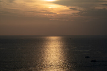 Naklejka premium Twilight Golden time in the sea view of Phrom Thep Cape, the tropical sea sunset period, scenic point of Phuket Island, The Pearl of the Andaman Sea,Thailand popular for tourist in the world.