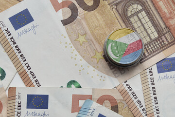 euro coin with national flag of comoros on the euro money banknotes background