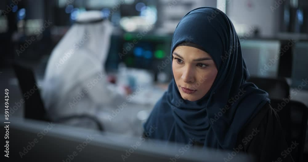 Aufkleber Portrait of a Thoughtful Middle Eastern Engineer Working on Computer in a Technological Corporate Office. Young Woman Writing Software Code for an Innovative Internet and Software as a Service Project