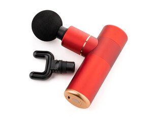 Modern massage gun for therapeutic muscle relaxation. percussion massager on a white background with a nozzle. The concept of sports recovery after training.