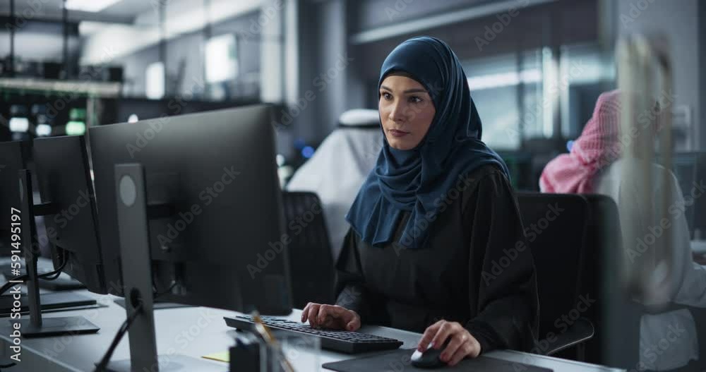 Aufkleber Young Arab Female Artificial Intelligence Engineer Working on Computer in a Technological Office. Young Middle Eastern Specialist Writing Software Code for an Innovative Big Data Blockchain Project