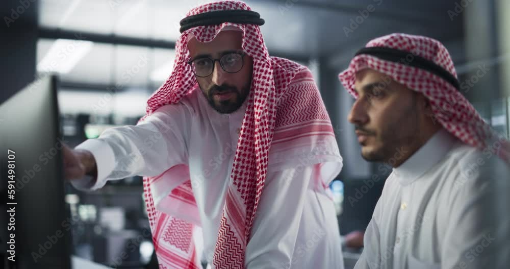 Poster Young Arab Software Developer Working on Computer, Discussing Project with Team Leader. Middle Eastern Data Protection Center with Servers, Storage Hardware and Cyber Security Research