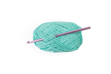 green thread spool with purple crochet hook