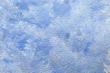 White and blue oil colors smudged on leather texture