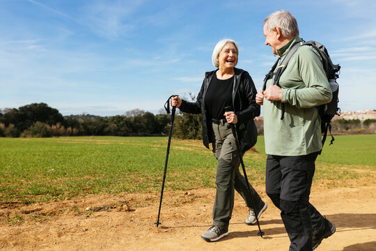 Happy senior couple hiking together in nature