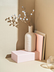 A minimalistic product promotion scene with a trendy interior in pastel colours. The closeup carries a spring time atmosphere. The photo suits for advertising presentation or a social media story.