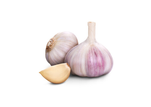 A whole fresh garlic head and clove segment isolated against a transparent background.