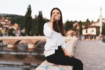 Fototapeta premium Young charming woman drinks coffee to go 