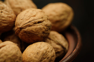 Walnut close up on a wooden table. Walnut close up. product rich in minerals and vitamins. Walnut turns in a shot. 