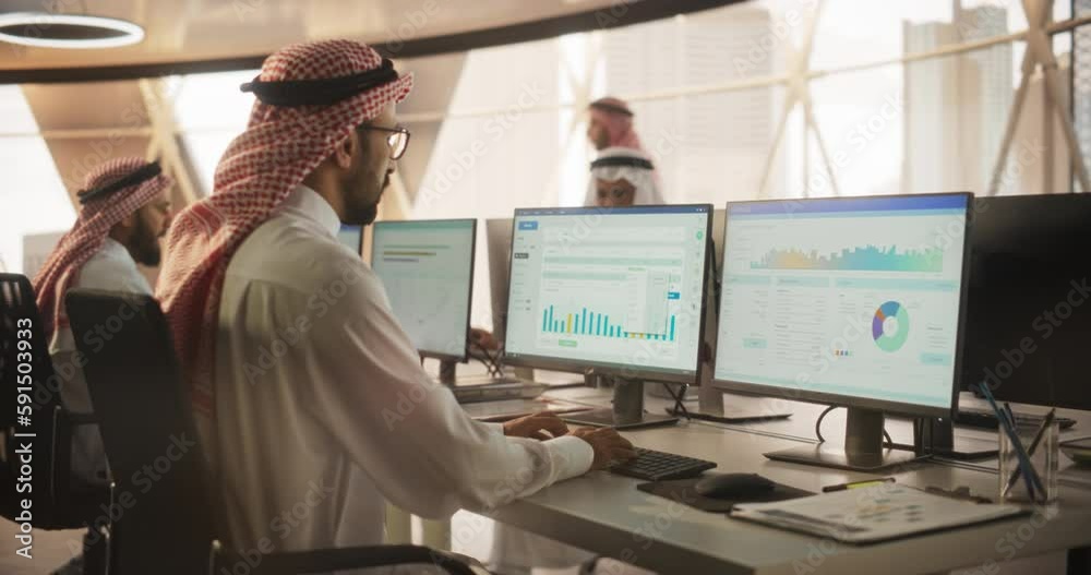 Poster arab market financial analyst working in a research and development facility on a desktop computer. 