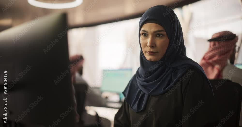 Aufkleber portrait of a middle eastern software developer working on computer in a technological corporate off