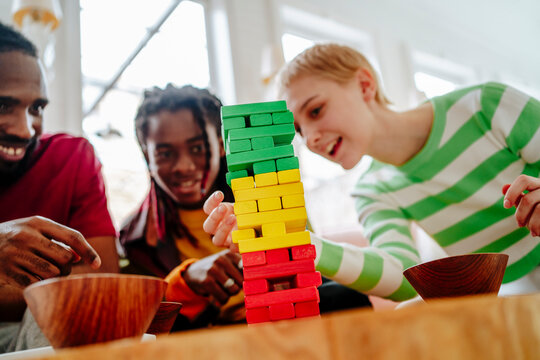 Young friends playing block removal game