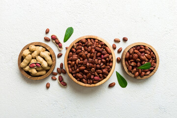 Fresh healthy peanuts in bowl on colored table background. Top view Healthy eating bertholletia concept. Super foods