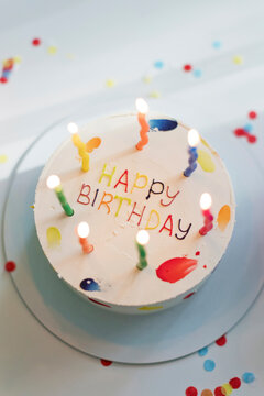 Birthday Cake With Illuminated Candles On Table