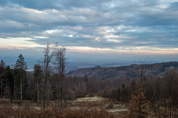 Plakat Landscape with mixed forest and colorful clouds at sunset. Early spring. View from Inovec hill, Slovakia.