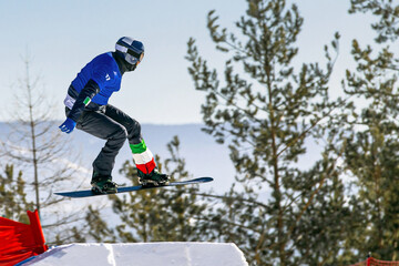 male italian snowboarders jumping drops in snowboarding competition, winter sports
