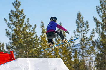 female snowboarders jumping drops in snowboarding competition, winter sports