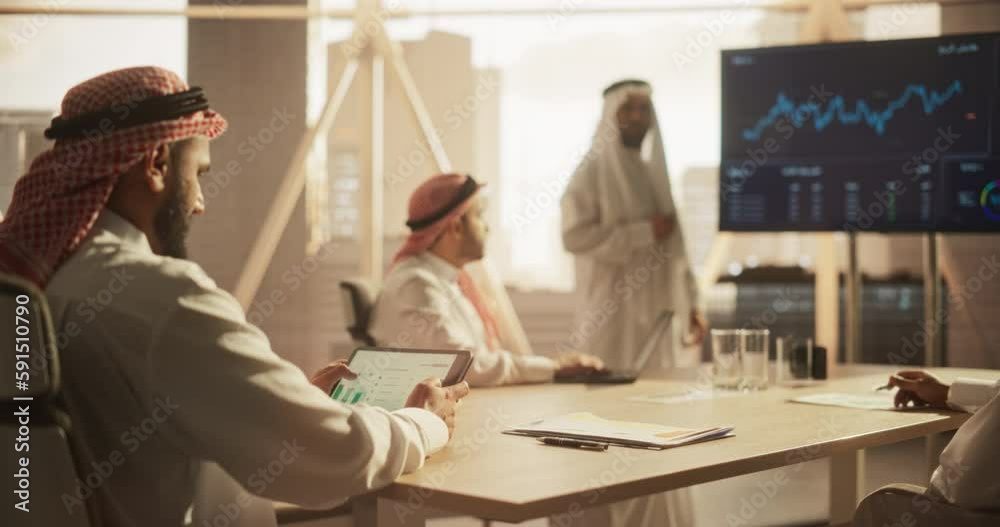 Aufkleber Muslim Businessman Using a Tablet Computer at a Meeting with Corporate Partners. Manager Getting Familiar with Financial Annual Report while Listening to the Presentation in Conference Room
