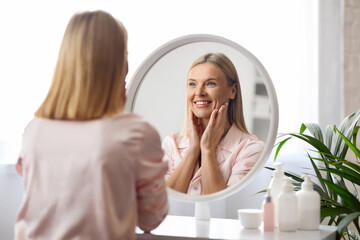 Mature Beauty. Attractive Middle Aged Lady Smiling To Her Reflection In Mirror