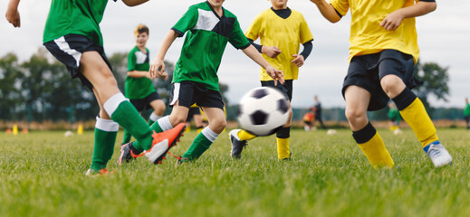 Group of Young Soccer Players Playing Football Game at Grass Venue. Happy Schooll Boys Kicking Soccer Ball. Sports Outdoor Competition Between Two Teams