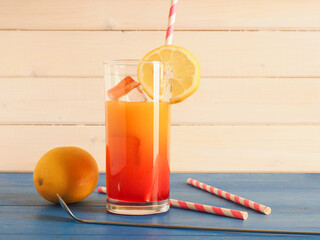 Tasty non alcoholic cocktail with orange and lemon juice and grendine syrup on ice