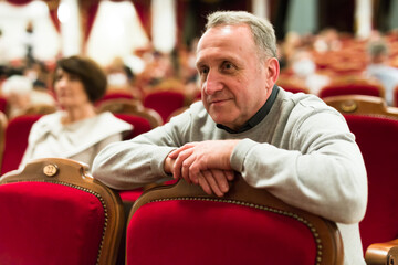 elderly couple watching play in the theater