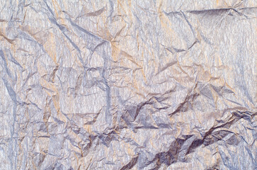 Background of silver and golden wrinkled crepe tissue paper
