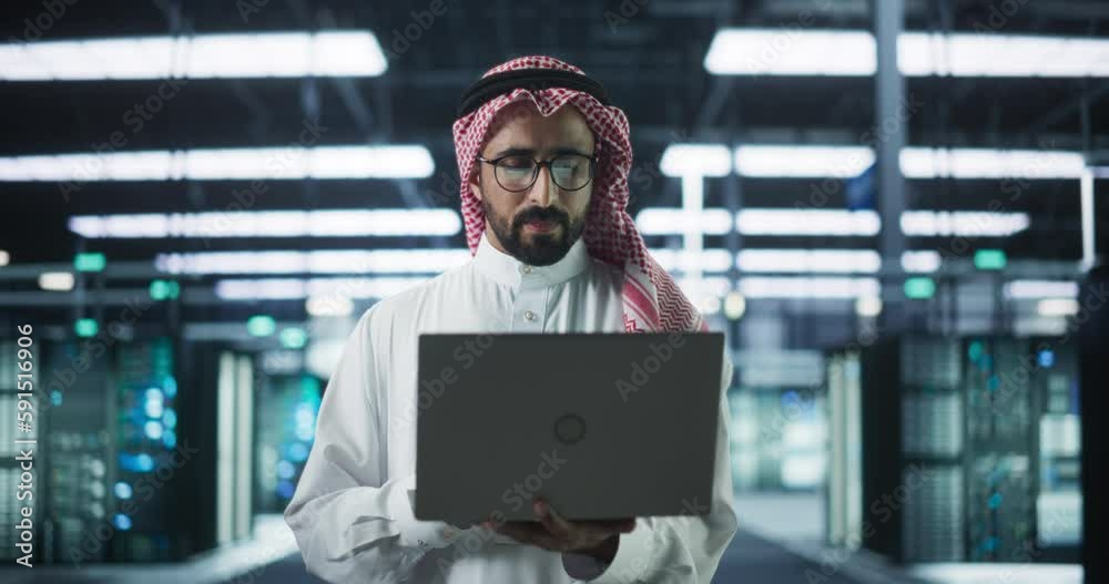 Poster portrait of a muslim data center technical manager wearing traditional white clothes, using laptop c