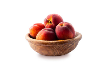 Peaches isolated on white background close-up. Macro. Peaches in a wooden bowl.