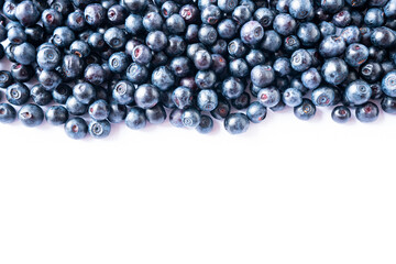 Bilberries on white background. Background blueberries. Ripe bilberries at border of image with copy space for text. Various fresh summer berries on white background. Top view. Background berries.