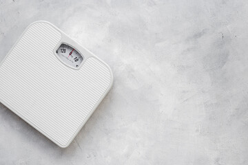Weight control concept. White weight scales from above