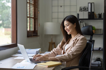 Young Happy Businesswoman Using Computer in Modern Office with Colleagues