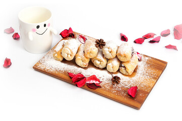 Fresh homemade baking and cup on white.