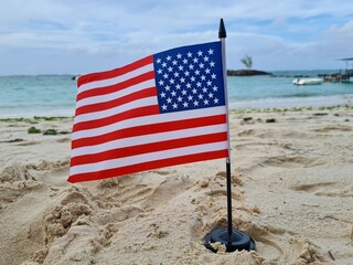 American flag on the beach and 4th of July Independence Day to commemorate or presidents