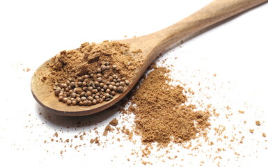 Coriander powder pile in wooden spoon isolated on white 