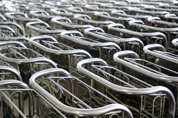 Background of Metal trolleys organized in rows at airport