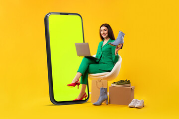 Mobile shopping concept. Lady sitting near giant cellphone and holding new shoes, buying online...