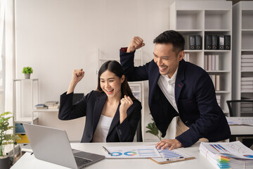 happy young couple have fun and relax in their office on working time.