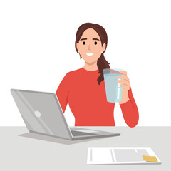 Young business woman holding glass of water in front of desk with laptop. Reminding people to stay hydrated and dont forget to drink water