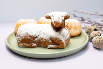Closeup Easter Sweet Lamb Pound Cake Sprinkled With Powdered Sugar, Quail Eggs, Easter Cupcakes Or Babeczki On Green Plate, Willow Branches. Traditional Easter Food Concept. Horizontal Plane