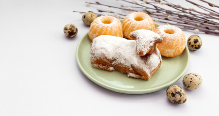 Closeup Easter Sweet Lamb Pound Cake Sprinkled With Powdered Sugar, Quail Eggs, Easter Cupcakes Or Babeczki On Green Plate, Willow Branches.Traditional Easter Food Concept.Horizontal Plane.Copy Space