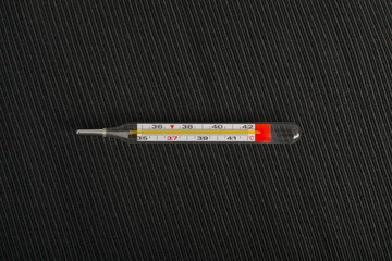 Medical Thermometer on Black Background, Temperature Measuring, Fever, Glass Medical Thermometer Top View